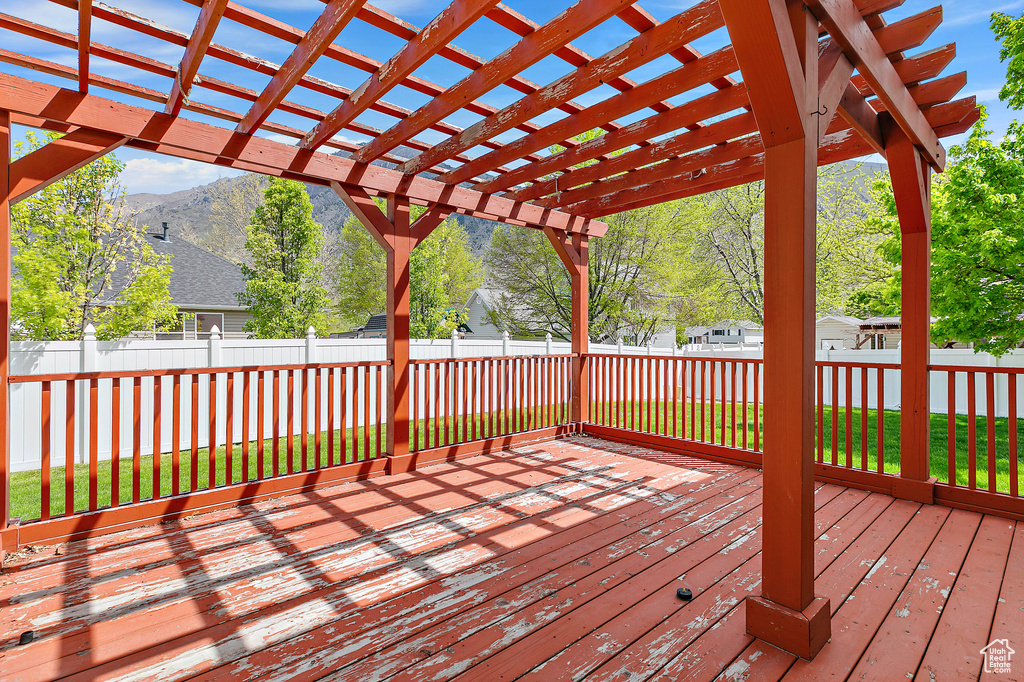 Deck featuring a mountain view and a pergola