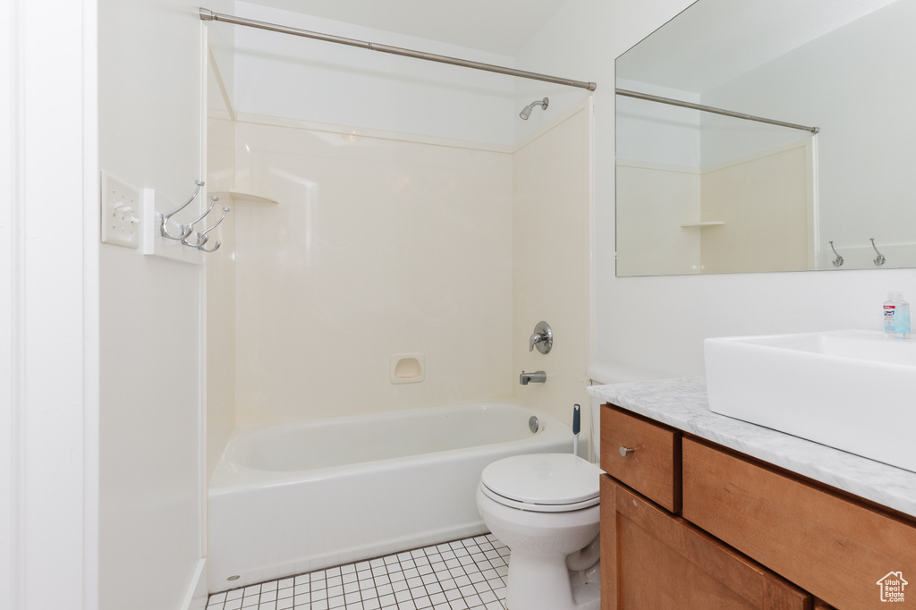 Full bathroom featuring shower / bathing tub combination, tile floors, toilet, and large vanity