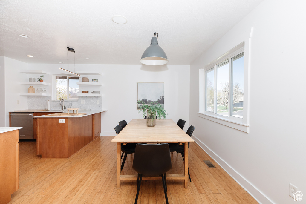 Dining room featuring sink and light hardwood / wood-style floors