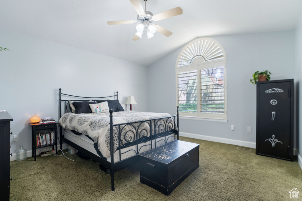 Bedroom featuring ceiling fan, vaulted ceiling, and carpet