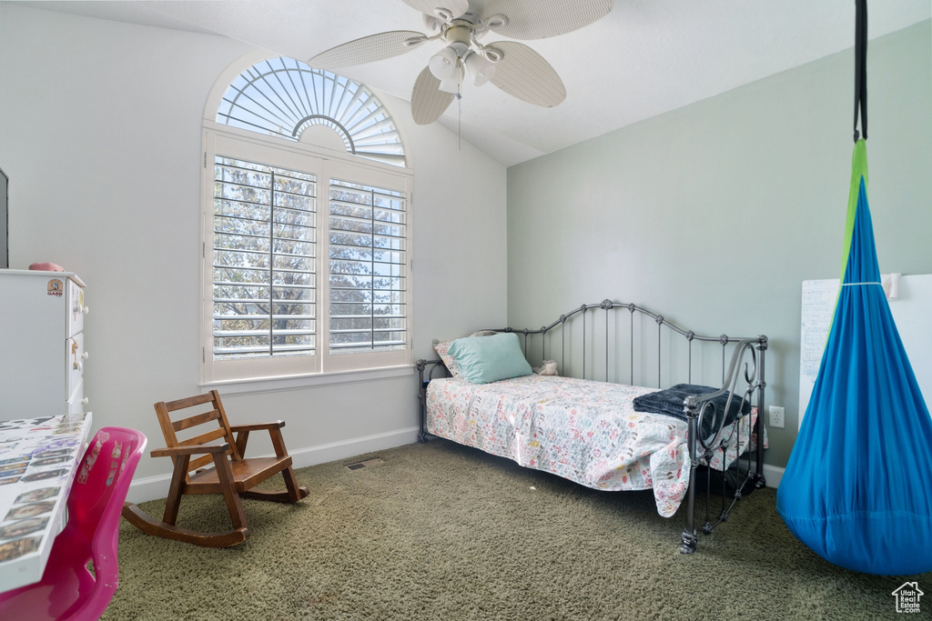 Bedroom with vaulted ceiling, ceiling fan, and carpet