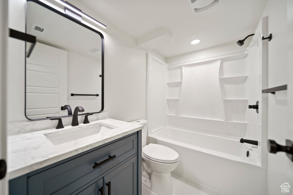 Full bathroom with oversized vanity, toilet, shower / bathing tub combination, and tile flooring