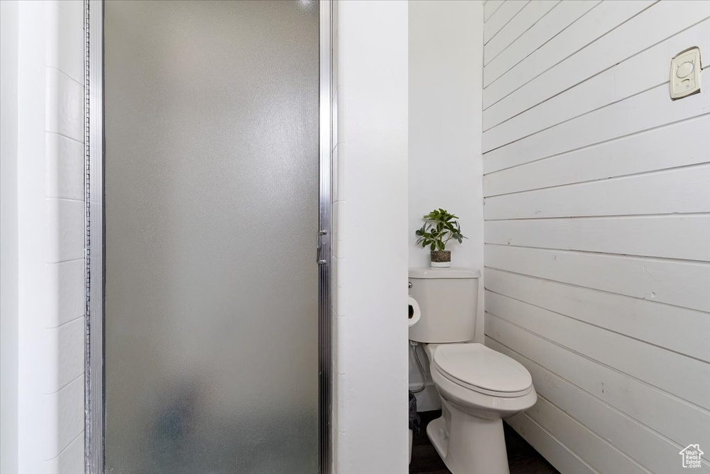 Bathroom with wood walls and toilet