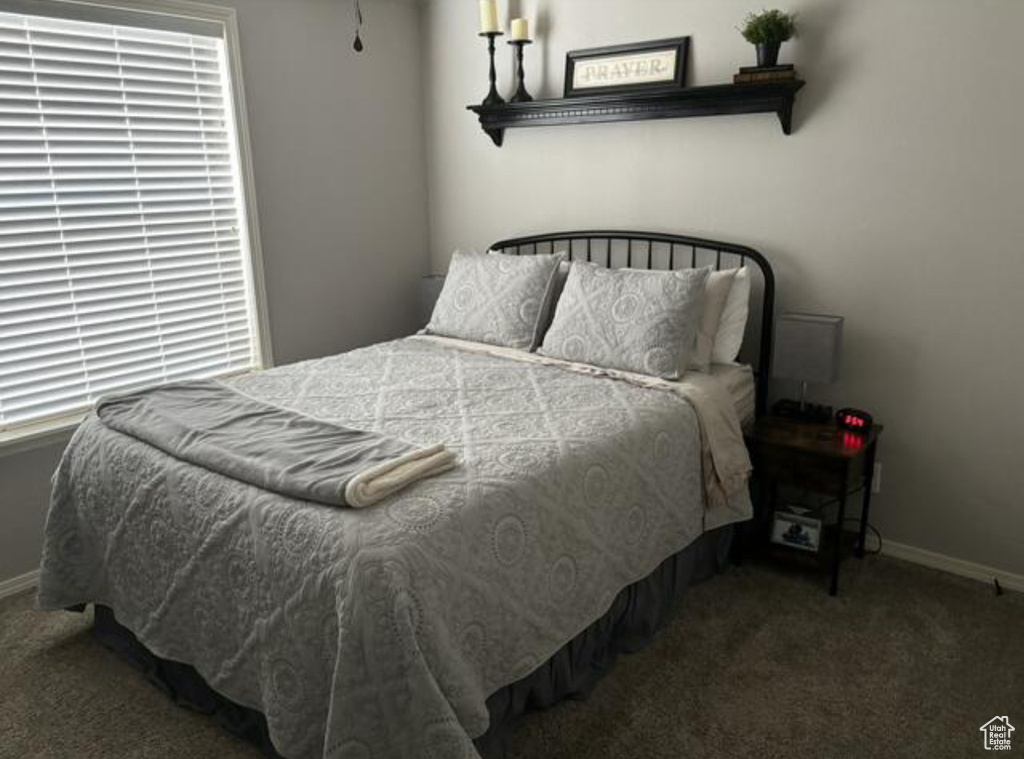 Bedroom featuring dark carpet