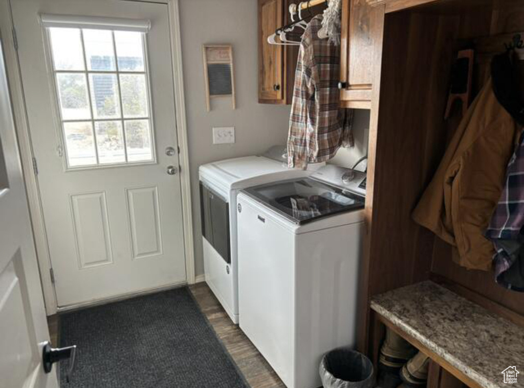 Laundry room with dark hardwood / wood-style flooring and washing machine and clothes dryer