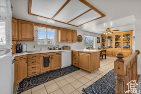 Kitchen featuring a wealth of natural light, ceiling fan, kitchen peninsula, and dishwasher