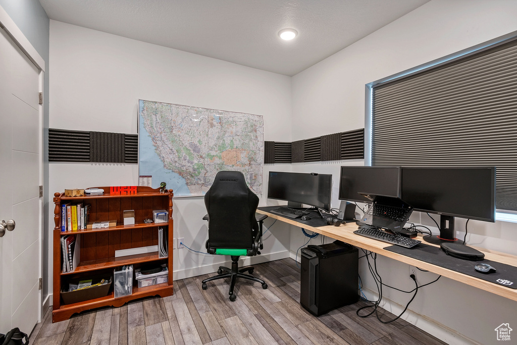 Office area with light hardwood / wood-style floors