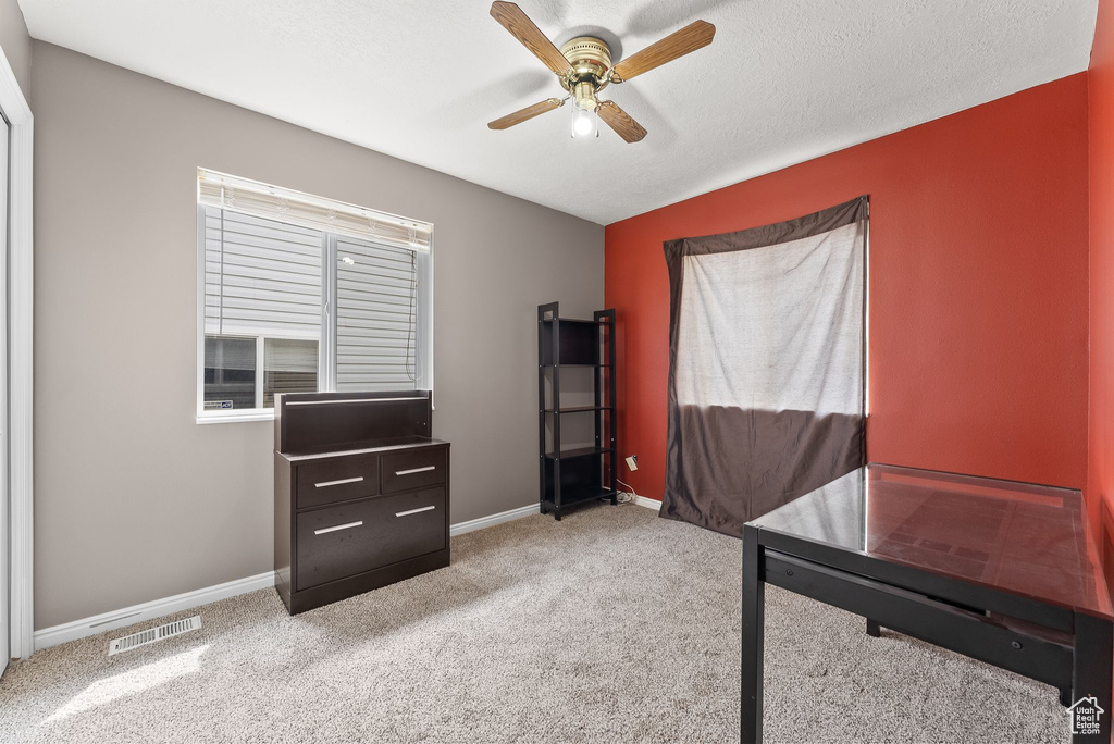 Interior space with ceiling fan and carpet