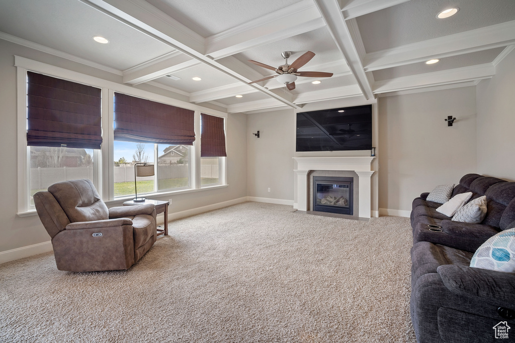 Living room with coffered ceiling, carpet, ceiling fan, and beamed ceiling