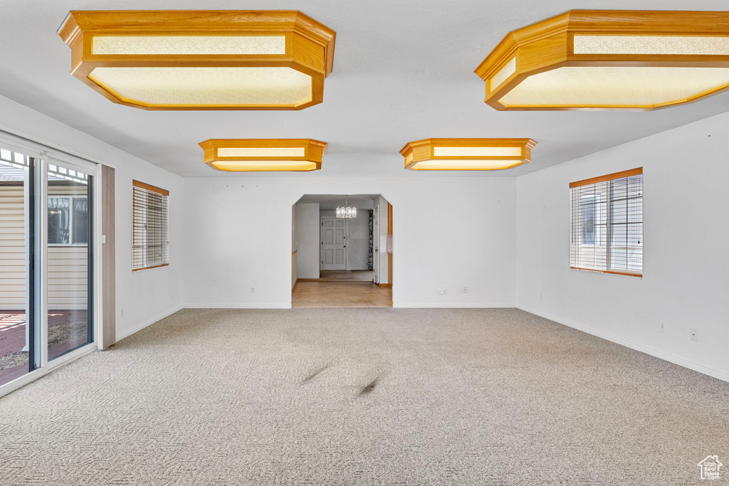 Empty room featuring a wealth of natural light and carpet floors
