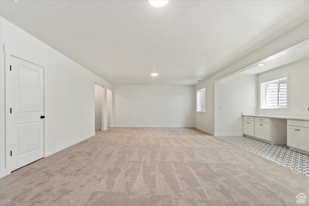 Interior space featuring light carpet and plenty of natural light