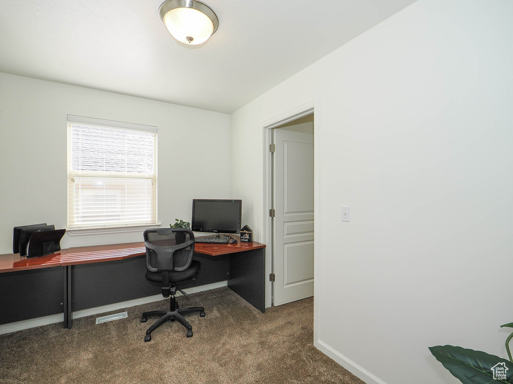Home office with dark carpet