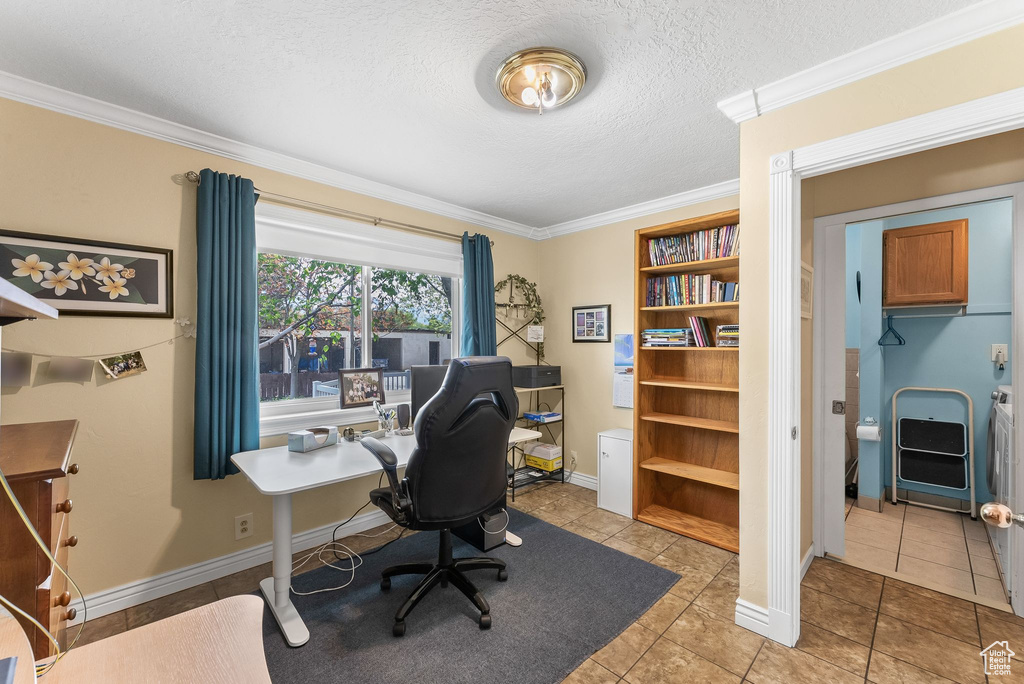 Tiled office space featuring a textured ceiling and crown molding