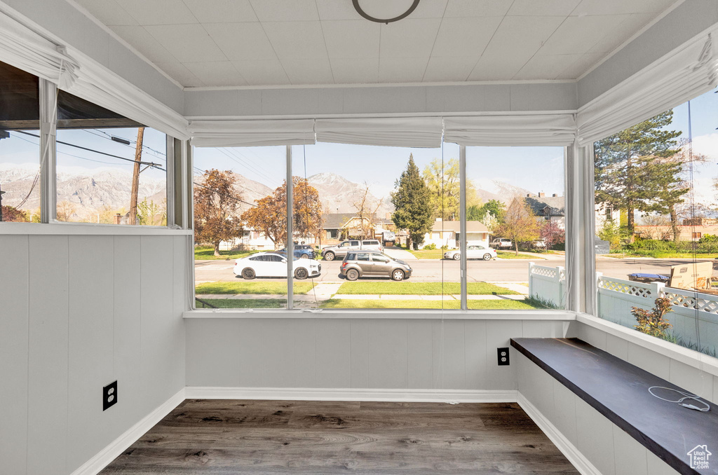 Unfurnished sunroom featuring a healthy amount of sunlight and a mountain view