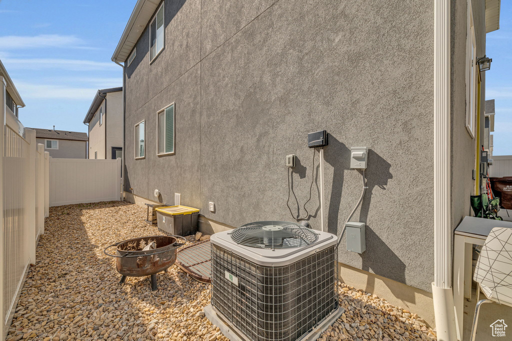 Exterior space with a fire pit and central air condition unit