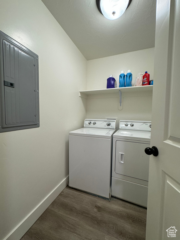 Clothes washing area featuring dark wood-type flooring and washer and dryer
