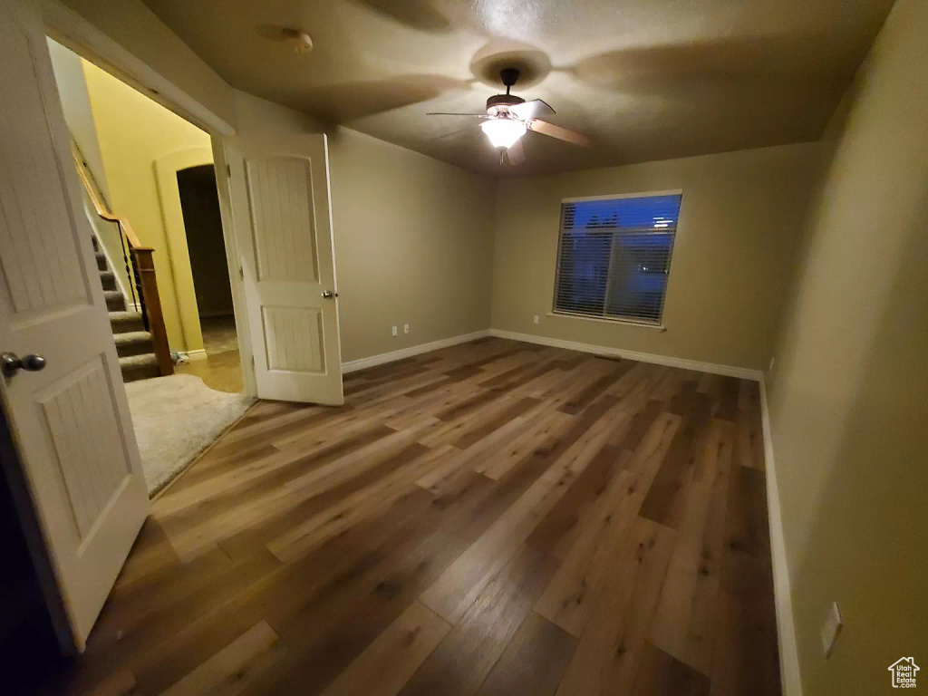 Unfurnished room with wood-type flooring and ceiling fan