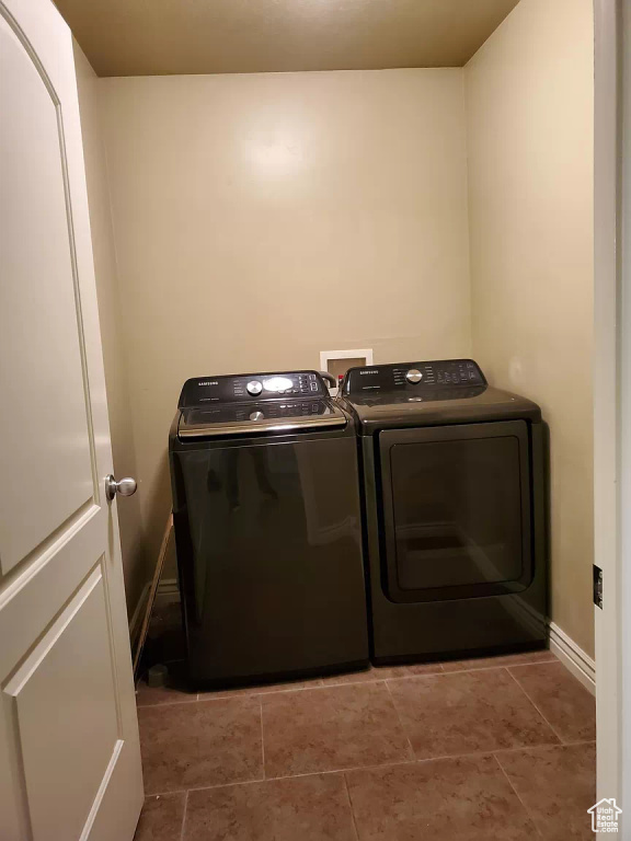 Laundry area with washer and clothes dryer, tile flooring, and hookup for a washing machine