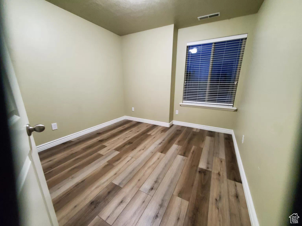 Empty room featuring hardwood / wood-style flooring