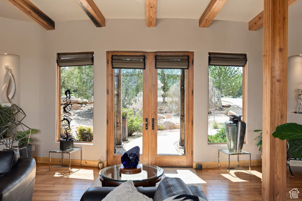 Entryway featuring french doors, wood-type flooring, and beamed ceiling
