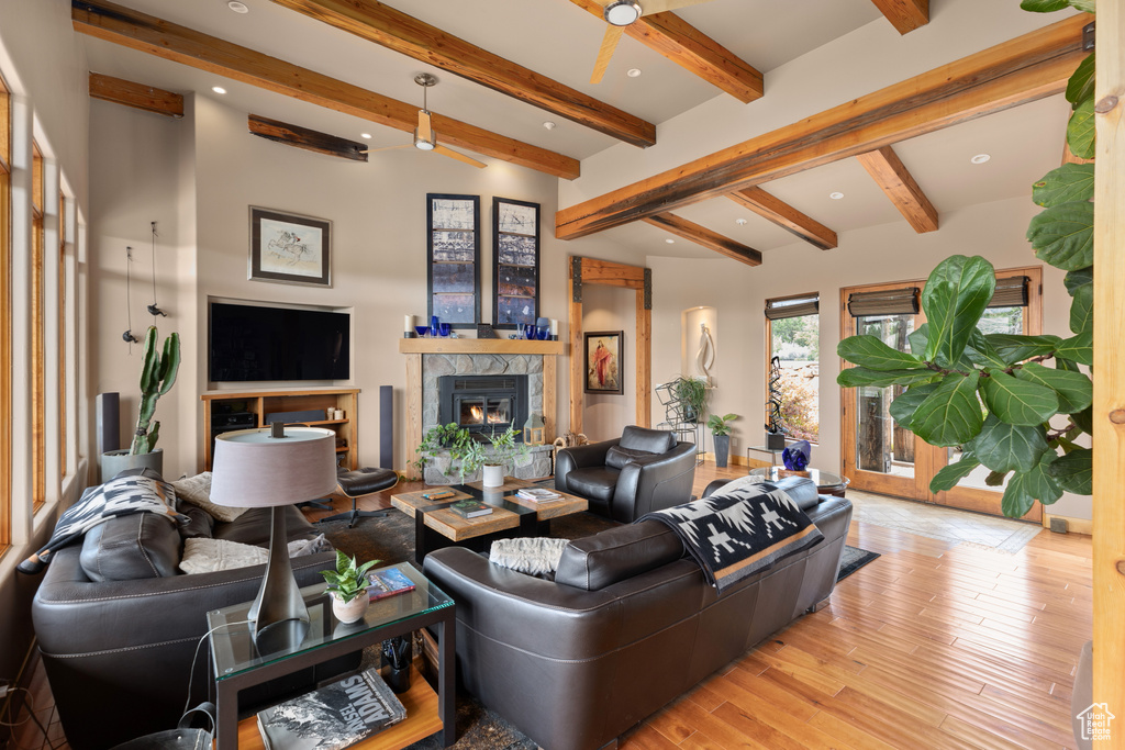 Living room with light hardwood / wood-style flooring and lofted ceiling with beams