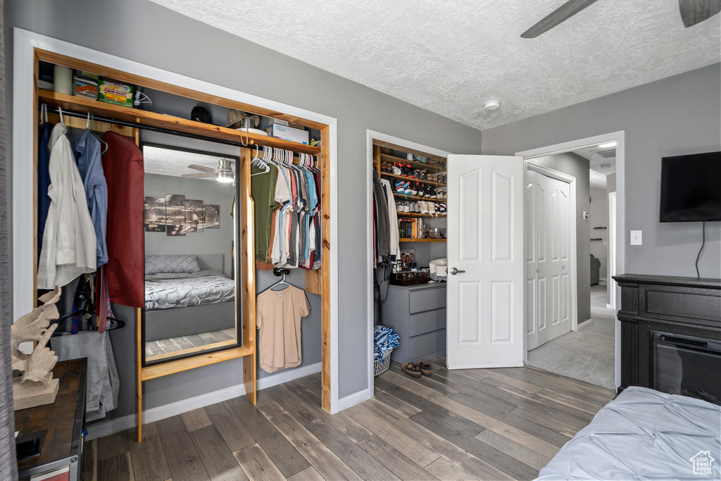 Carpeted bedroom featuring a textured ceiling, ceiling fan, and washer and clothes dryer