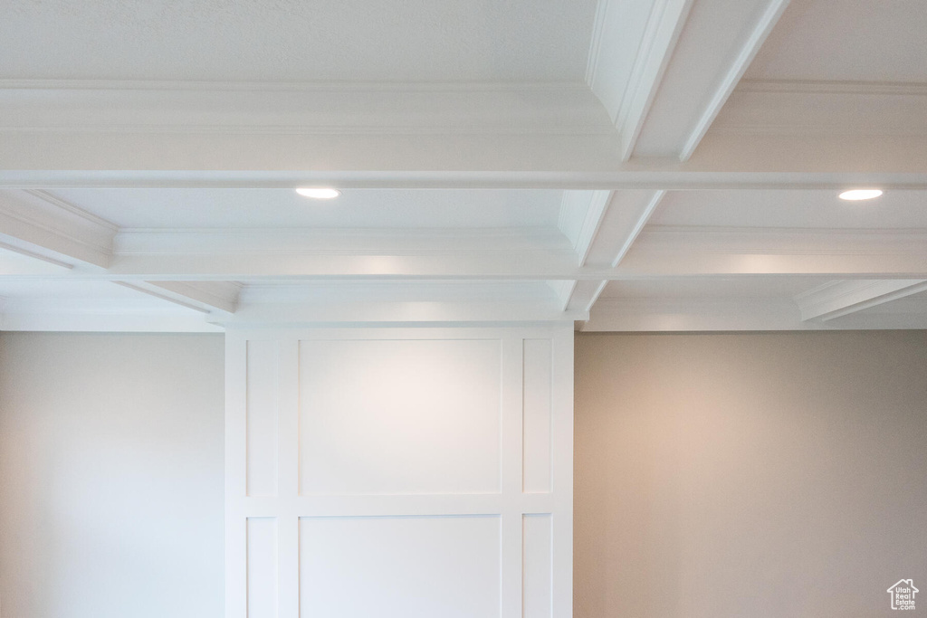 Interior details with beamed ceiling, ornamental molding, and coffered ceiling