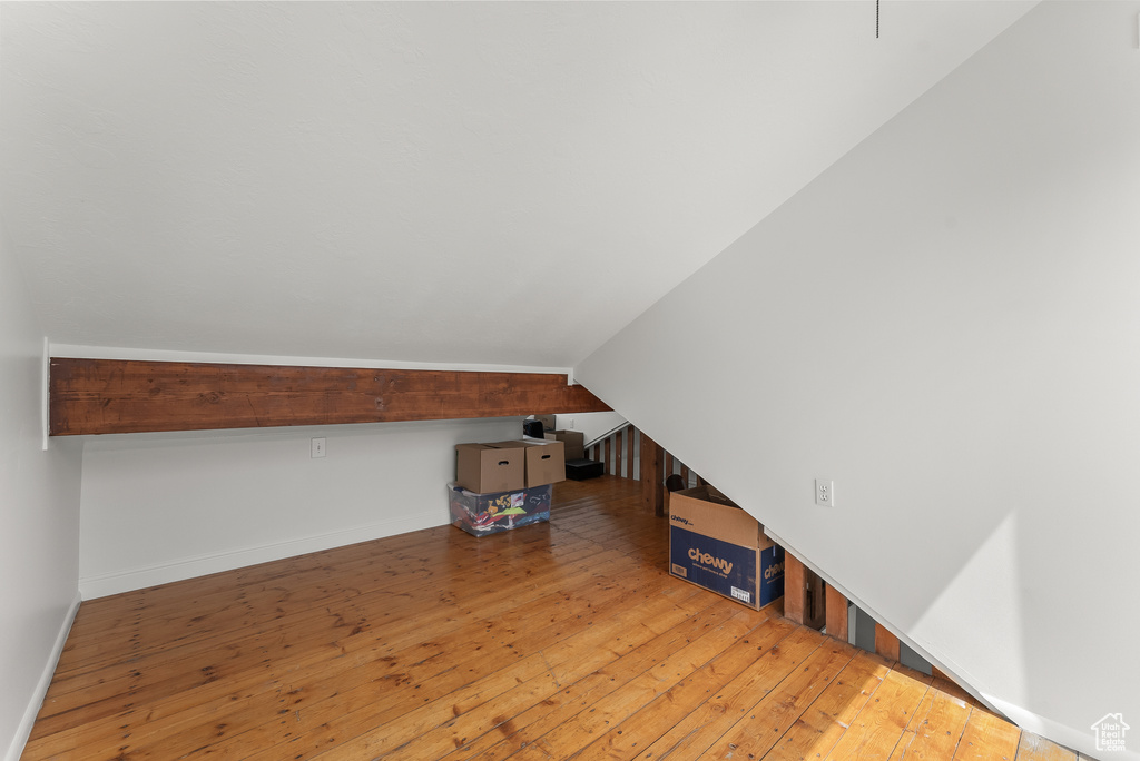 Additional living space featuring light hardwood / wood-style floors and vaulted ceiling