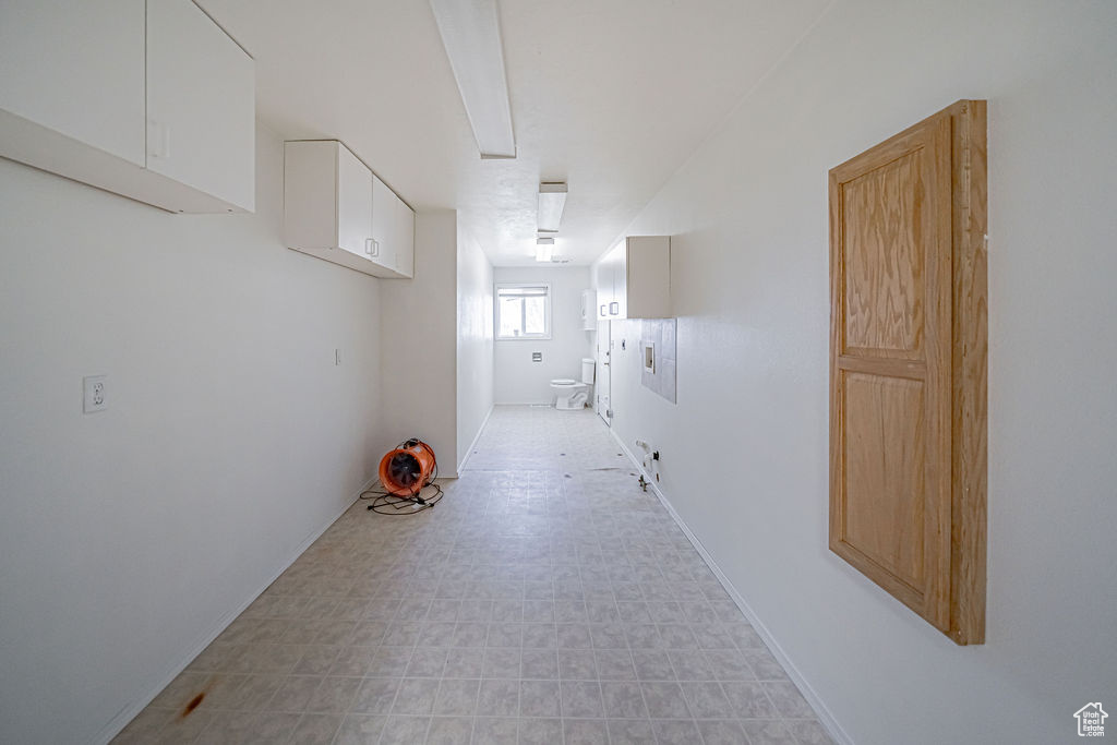 Corridor with light tile flooring