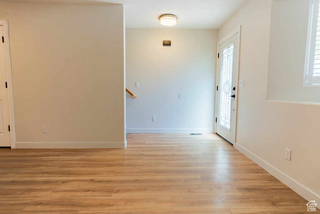 Unfurnished room featuring plenty of natural light and light hardwood / wood-style floors
