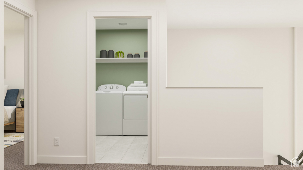 Washroom featuring light carpet and washer and dryer