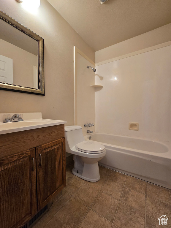 Full bathroom with bathtub / shower combination, vanity, and toilet