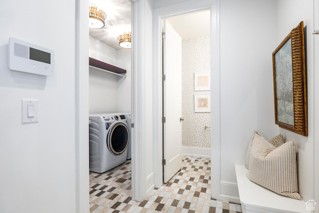 Laundry room featuring light tile floors and washer / dryer