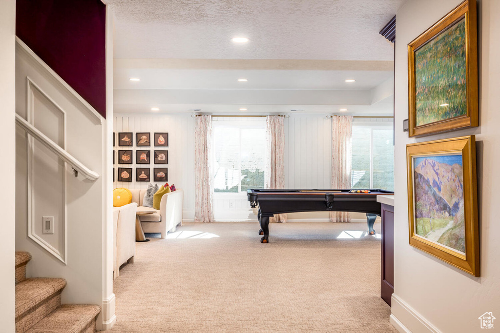 Playroom with a textured ceiling, carpet floors, and billiards