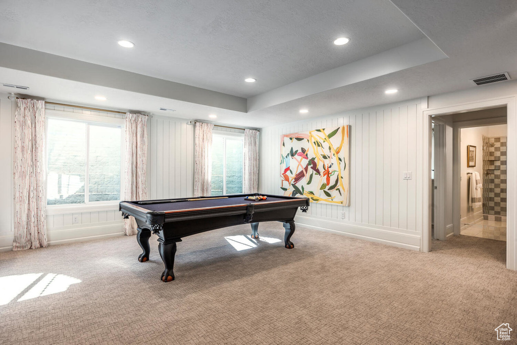 Game room with light colored carpet, a tray ceiling, and pool table