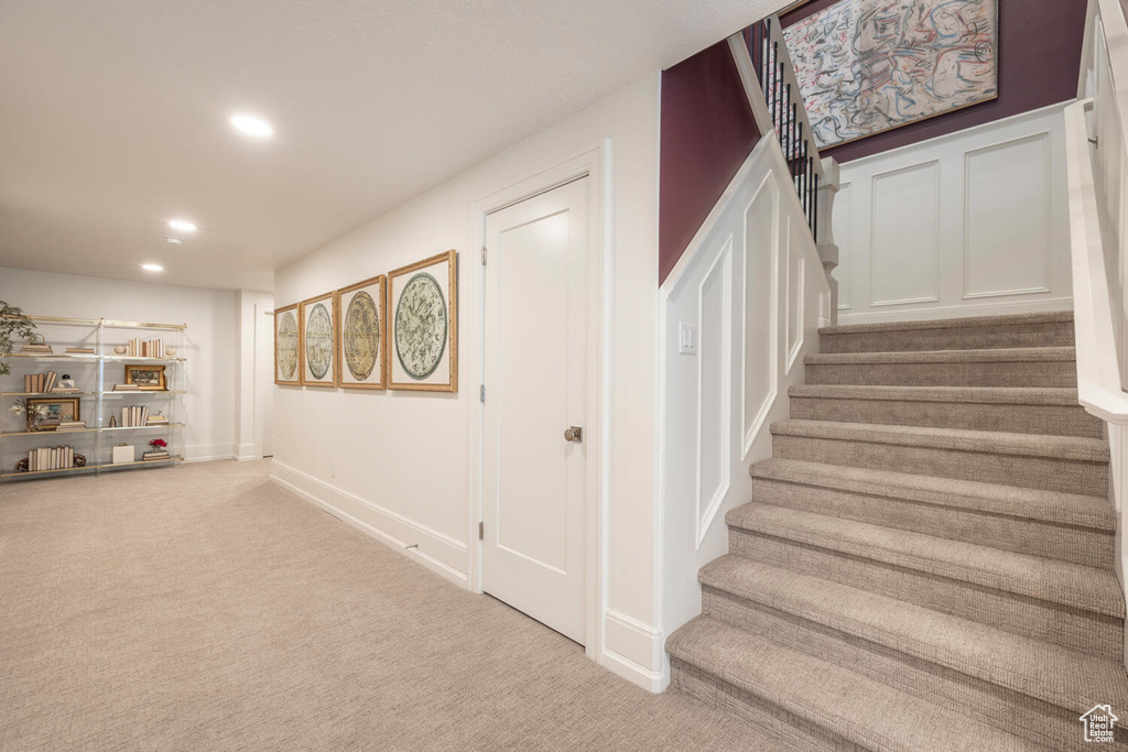 Staircase featuring carpet