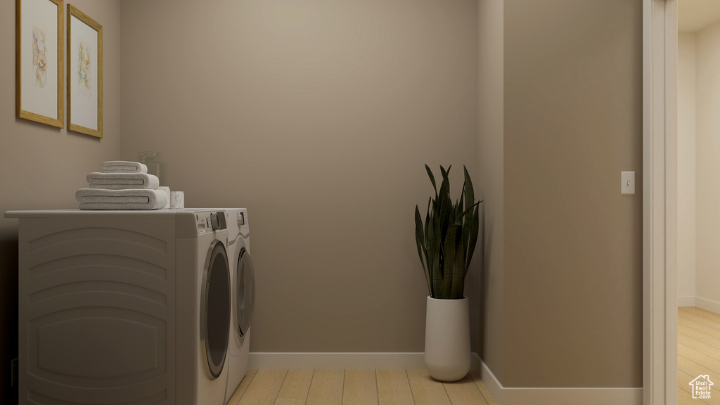 Laundry area featuring hardwood / wood-style floors and independent washer and dryer