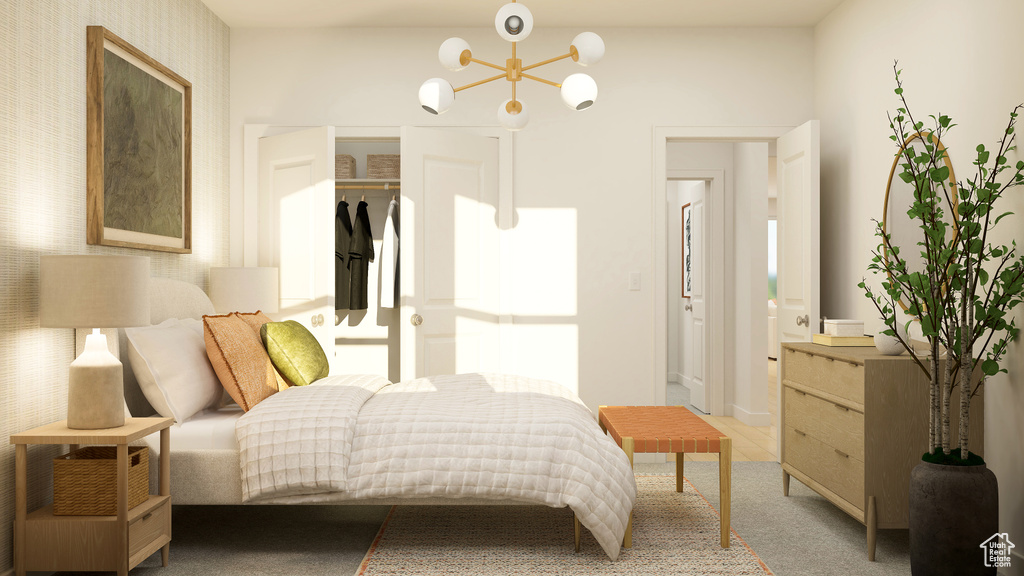Bedroom featuring a closet, carpet flooring, and an inviting chandelier