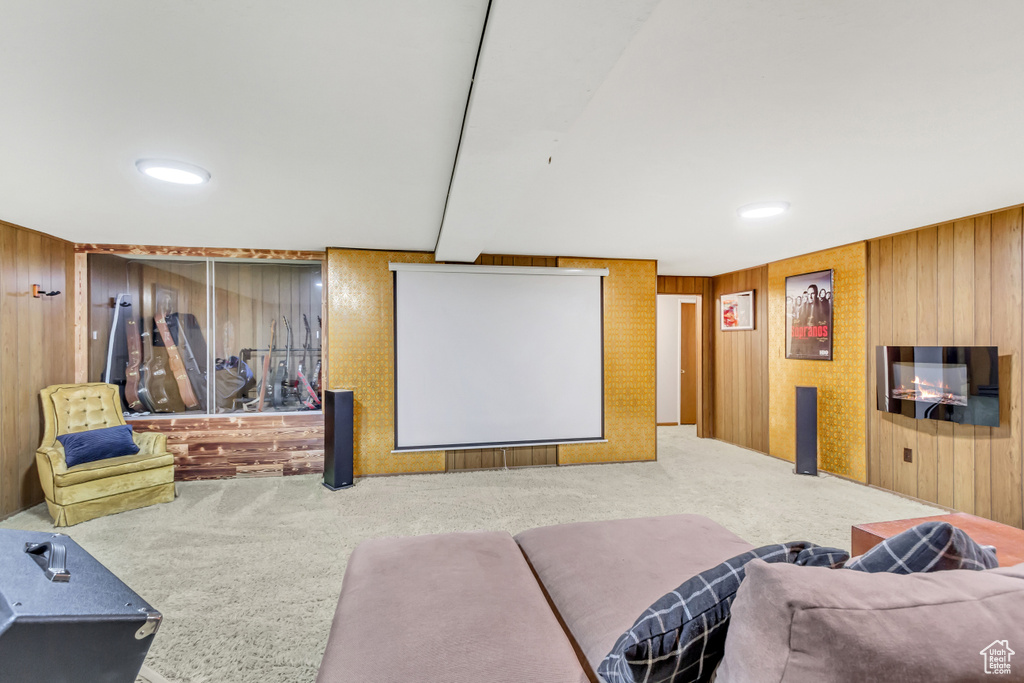 Home theater with carpet and wooden walls