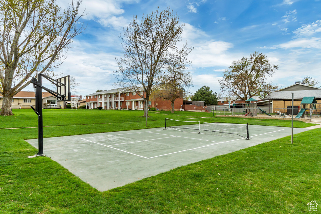 View of basketball court featuring a playground, tennis court, and a lawn