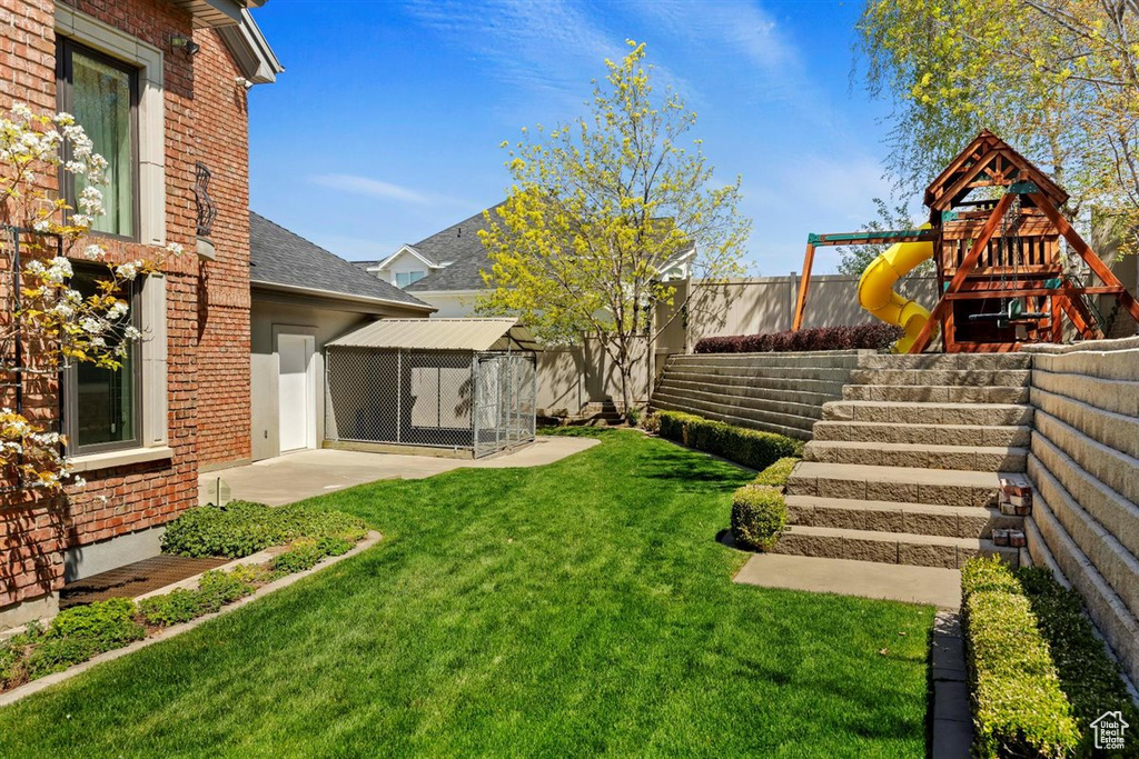 View of yard featuring a patio and a playground