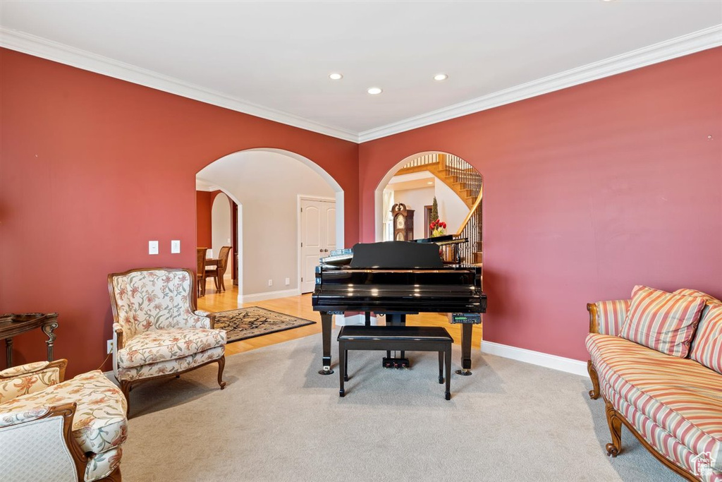 Sitting room featuring carpet flooring and ornamental molding