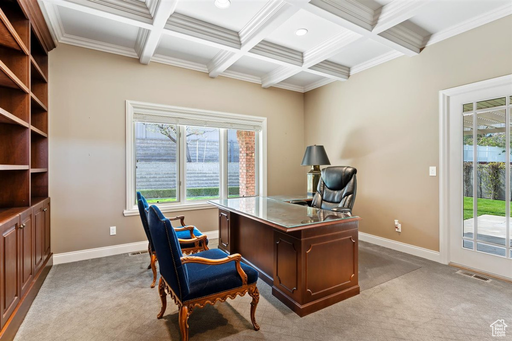 Office space featuring beamed ceiling, light carpet, coffered ceiling, and ornamental molding