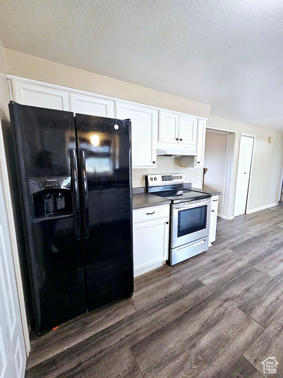 Kitchen featuring white cabinetry, dark hardwood / wood-style floors, black fridge, and stainless steel electric range