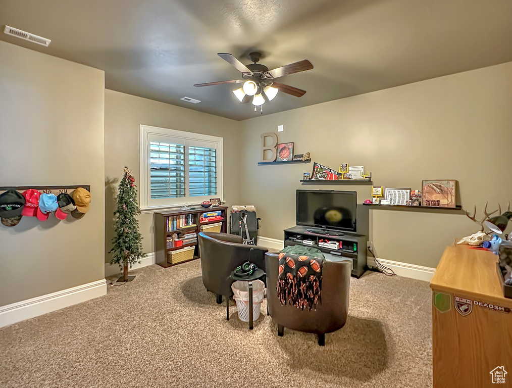 Office area with ceiling fan and carpet flooring