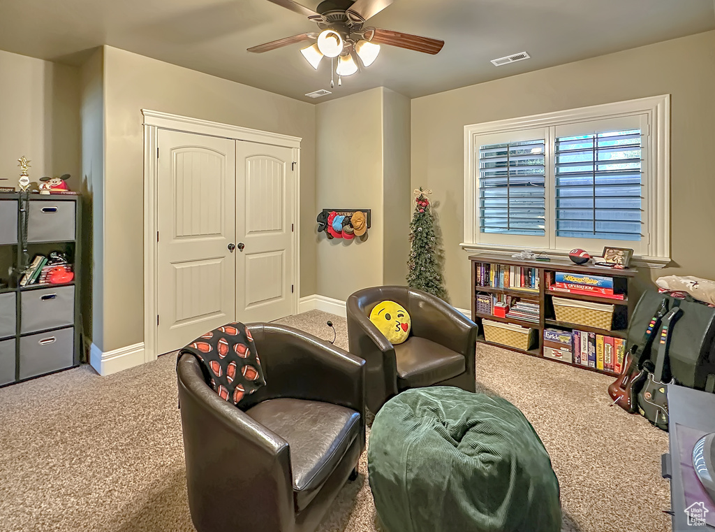 Game room with carpet floors and ceiling fan