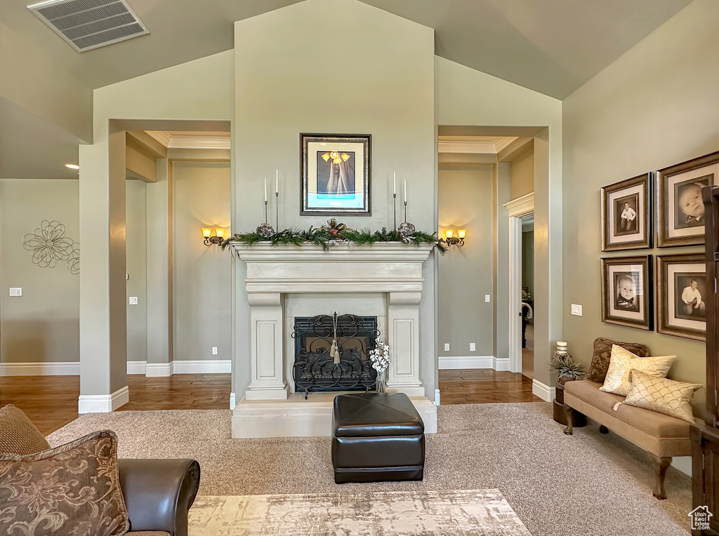 Living room featuring vaulted ceiling and hardwood / wood-style floors