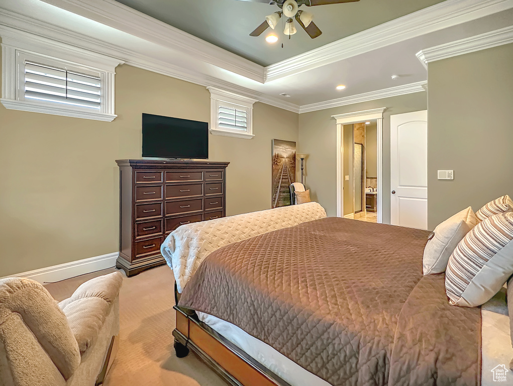 Bedroom with crown molding, ceiling fan, and a raised ceiling