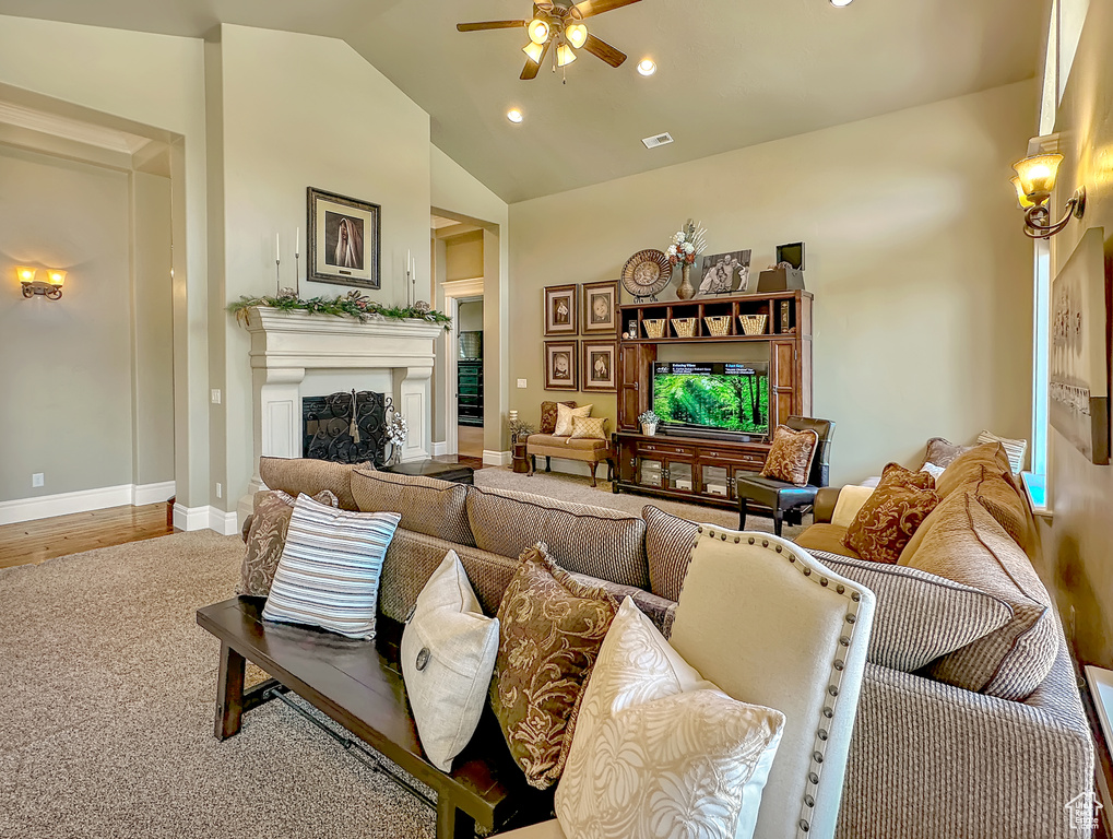 Living room featuring hardwood / wood-style floors, ceiling fan, and high vaulted ceiling
