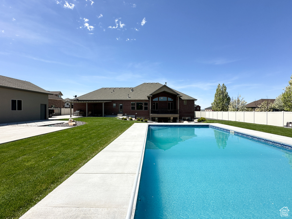 View of pool featuring a patio area and a yard